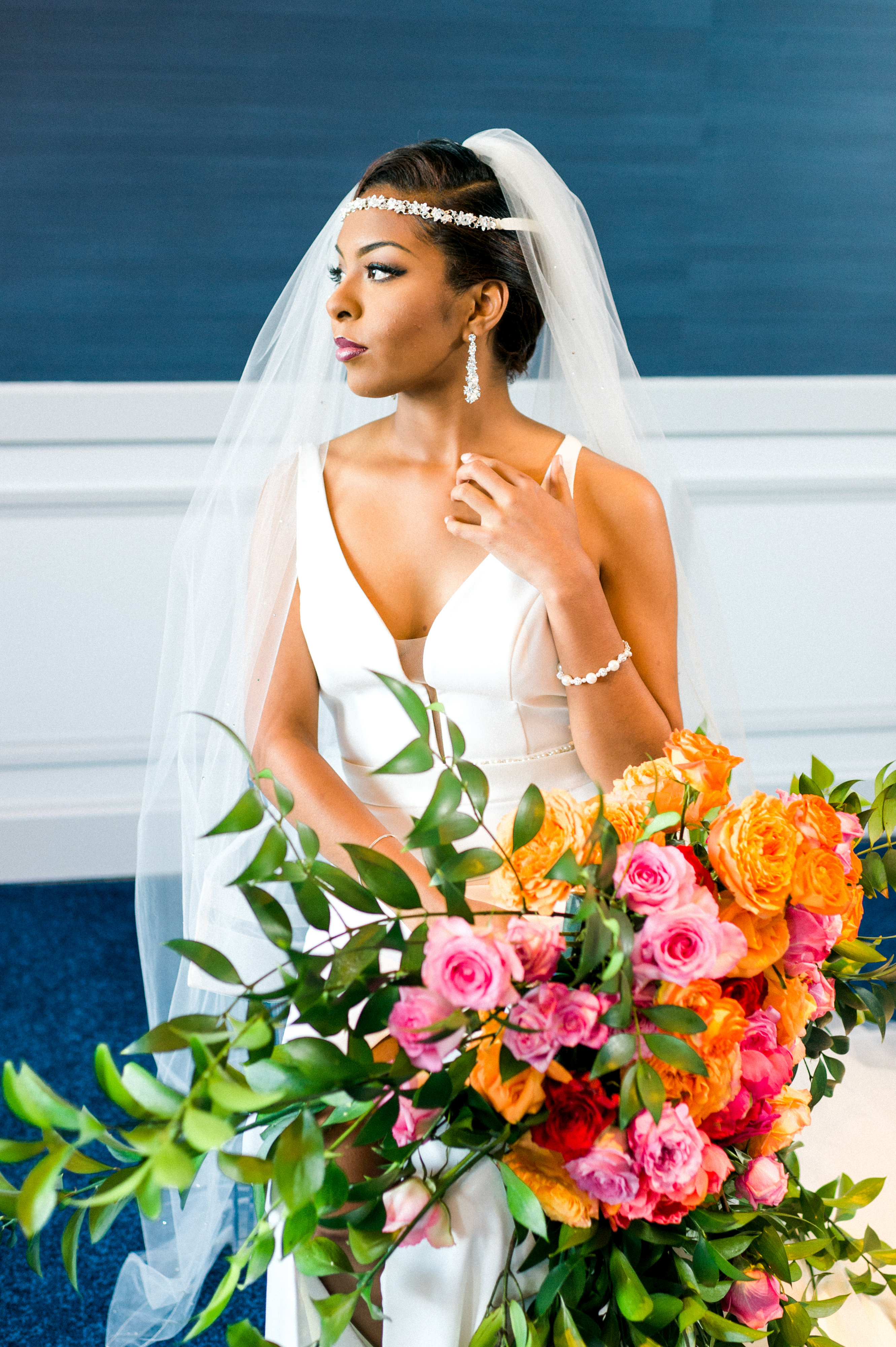 E'MAGNE Events & Co - North Carolina luxury wedding planner - branded logo - orange and navy blue wedding - bride with orange and fuchsia bouquet