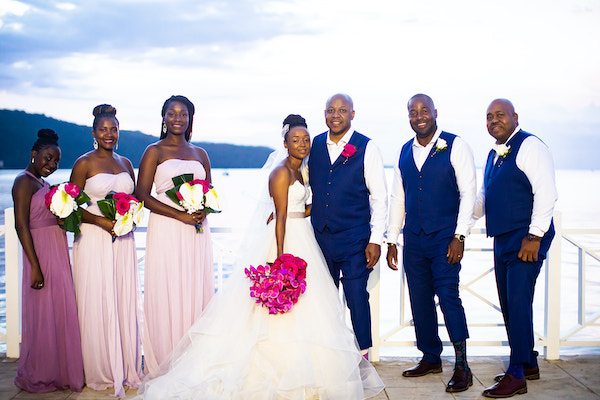 North Carolina Destination wedding planner- Jamaican destination wedding - bride and groom with wedding party - bride with hot pink bridal bouquet - groom with rosy blue vest - tropical bouquets - Moon Palace Jamaica