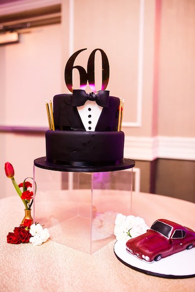 60th birthday black tuxedo cake sitting next to a custom red sportswear cake
