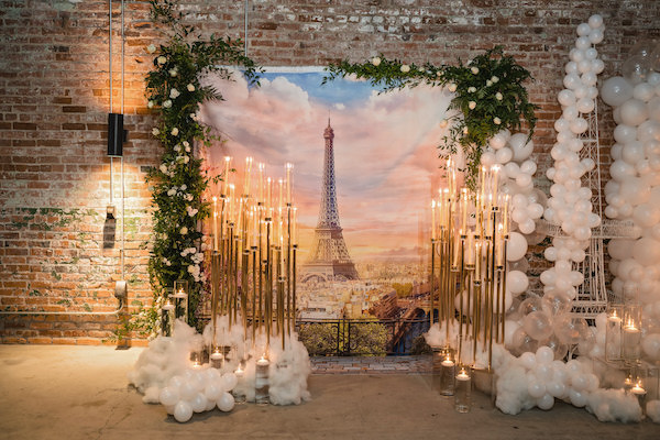 AParis themed backdrop with balloons and candles for a wedding proposal in Durham North Carolina